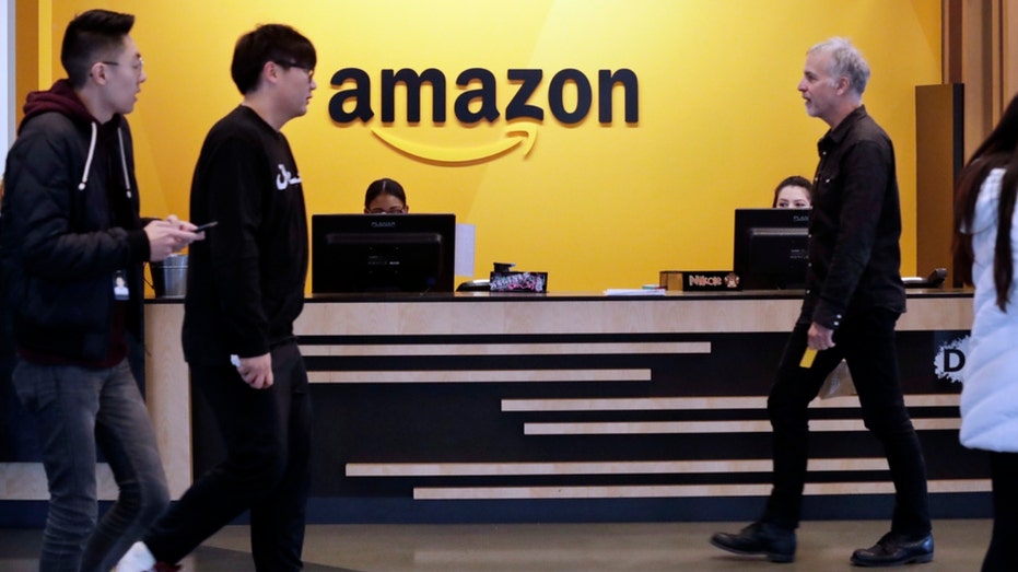 Employees walk through a lobby at Amazon's headquarters