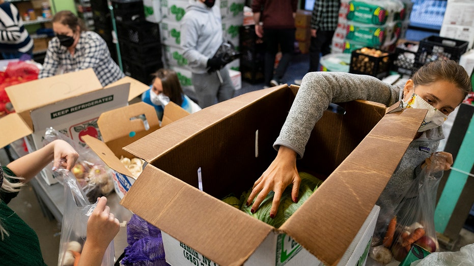Volunteers package and distribute food
