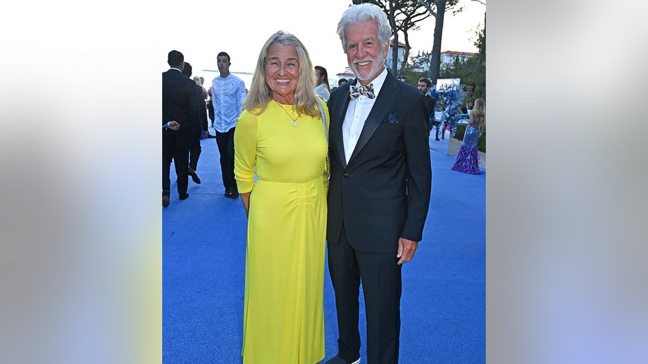 Leonardo DiCaprio's mother beams in a yellow gown standing next to her husband David Ward at the amfAR Cannes Gala 